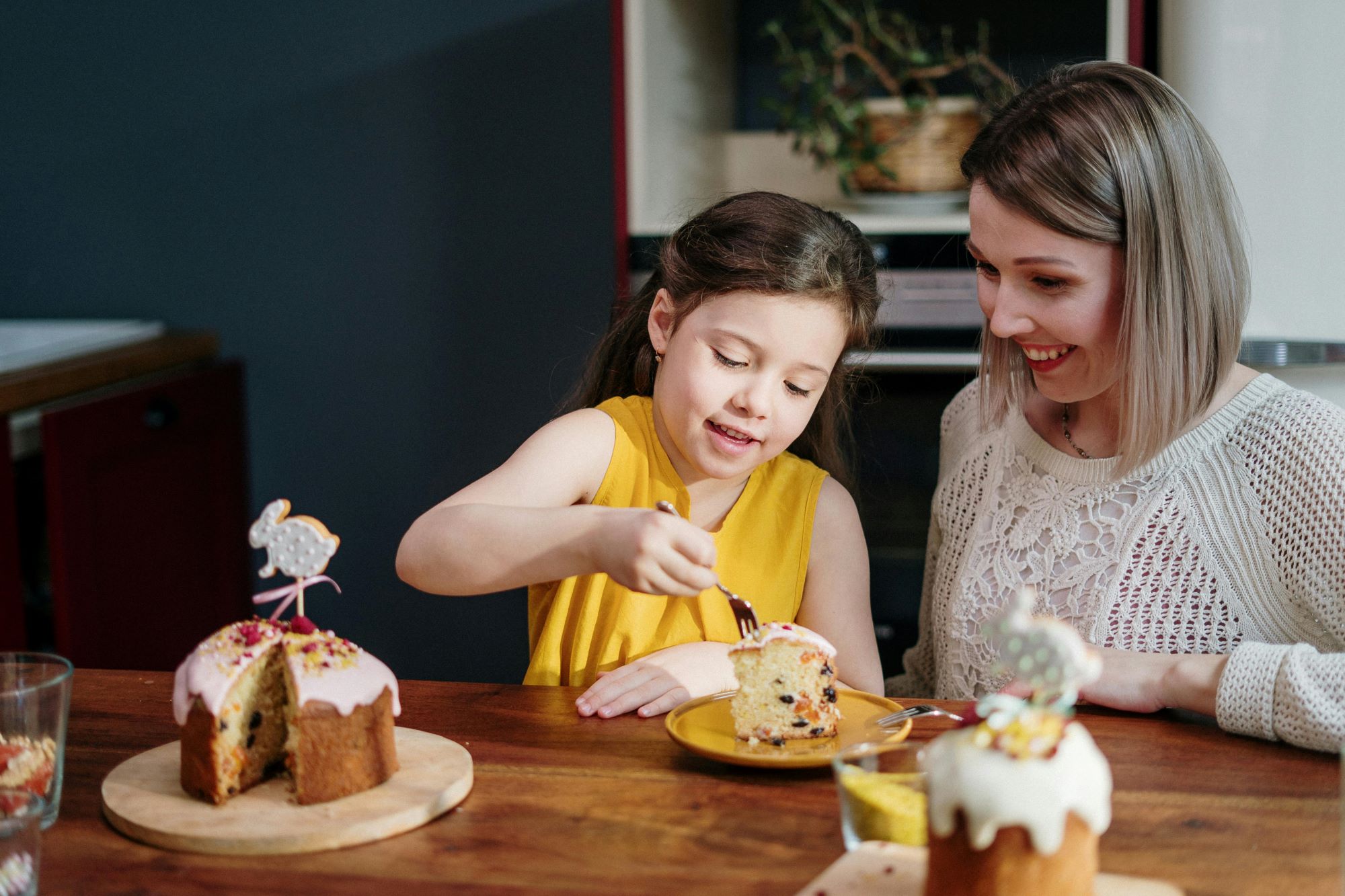 Tradycje kulinarne na Wielkanoc w Wielkiej Brytanii to także słodkości. Na zdjęciu dziewczynka z mamą dekorują ciasto.